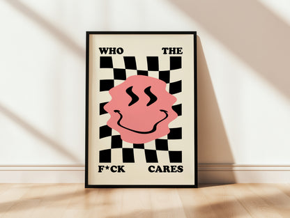 Framed poster with a pink smiley face and black and white checkered pattern on a beige wall.