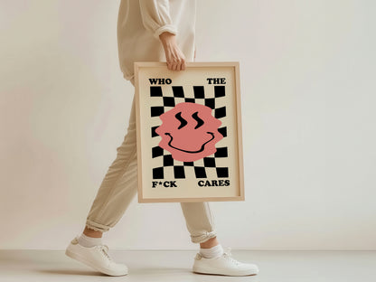 Person holding a framed poster with a checkered design and text on a plain background
